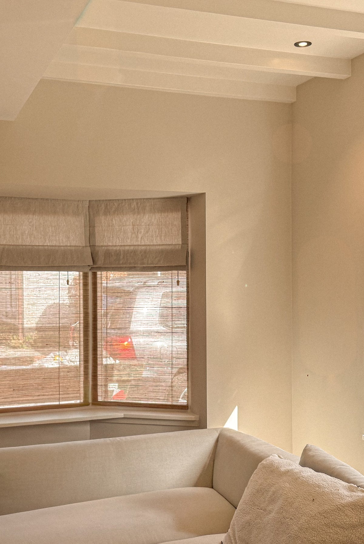 Oatmeal Baltex blinds and linen Roman shades in a stylish window treatment setup by BALTEX BLINDS
