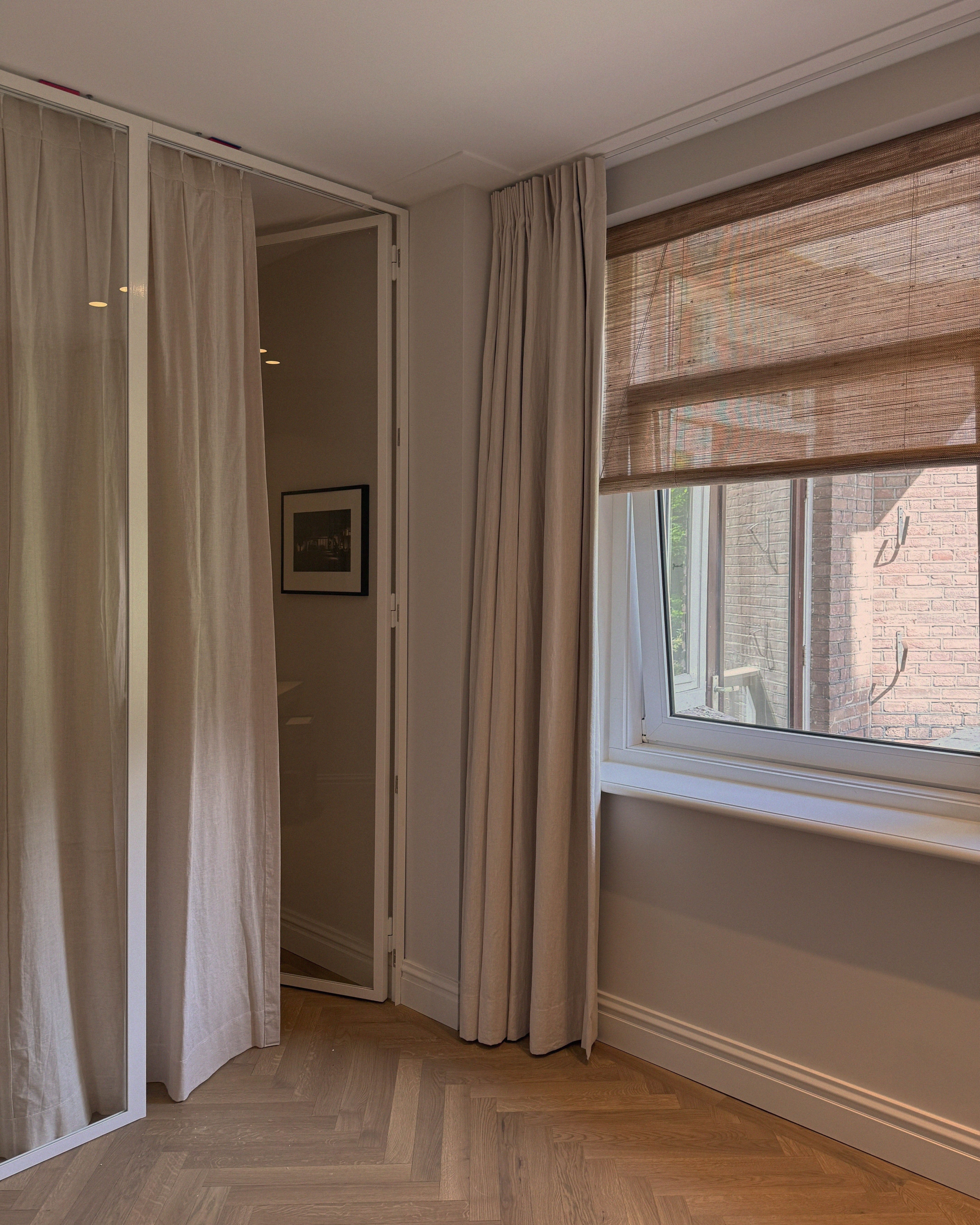 rolgordijnen en gevoerde linnen gordijnen in combinatie in een slaapkamer